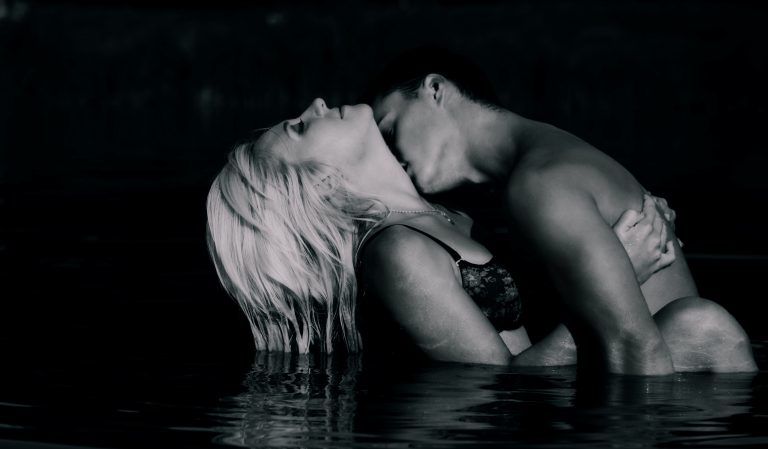 Man kisses girl in swimming pool