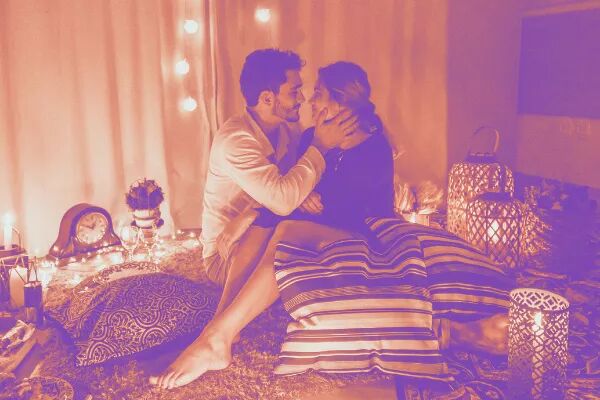 Valentines day guy and girl on bed kissing