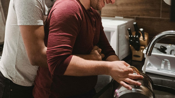 Want More Sex? Two men cuddling in a kitchen