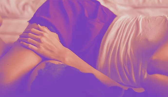 Lube Myths lady laying on bed in lingerie