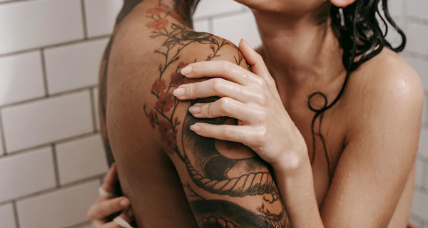 man and woman naked in shower