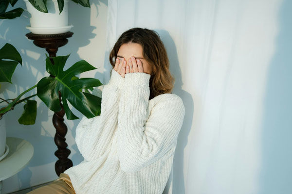 girl feeling embarrassed with hands over eyes