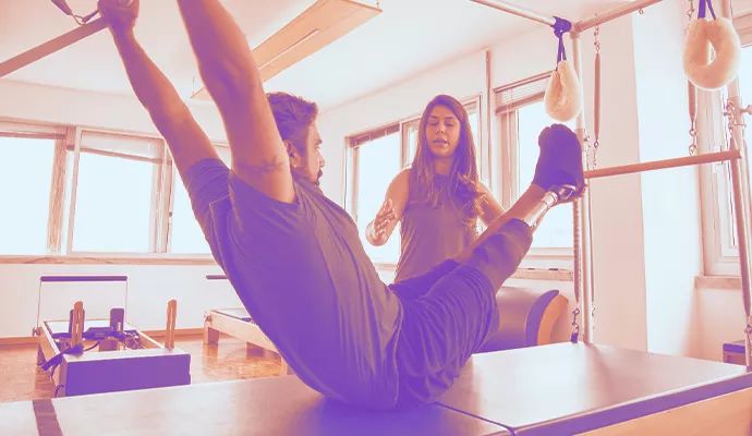 Man at gym using machine.